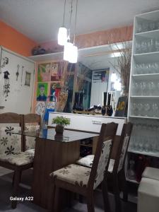 a dining room with a glass table and chairs at apartamento cop30 in Ananindeua