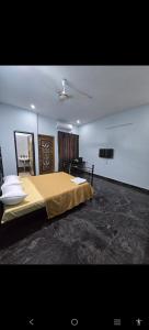 a bedroom with a large bed and a desk at perumal home stay in Tiruvannāmalai