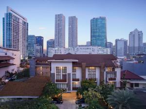 a building in front of a city with tall buildings at Rasuna Mansion in Jakarta