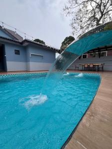 a water fountain in a swimming pool at Eiffel Villa Homestay in Simpang Empat +7 photos