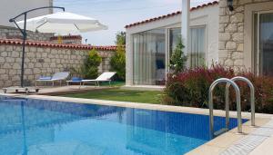 a swimming pool in front of a house at LuCe Design Hotel - Special Category in Alaçatı