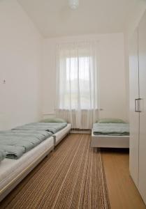 a bedroom with two beds and a window at Hostel Valtice in Valtice