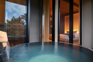 a table in a room with a bed and a bedroom at プライベートリゾート仙居 in Hakone