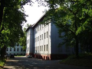 a white building with a lot of windows on a street at Hostel Valtice in Valtice