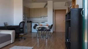 a small kitchen with a table and chairs in a room at AdrianApartments ViVa in Cluj-Napoca