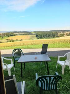 a table and chairs with a laptop on top of it at NF Alpenvorland 