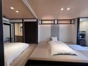 a bedroom with two beds and a large window at Jasmin錦町5F in Takamatsu +25 photos