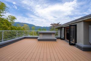 a balcony with a bench on top of a building at プライベートリゾート仙居 in Hakone