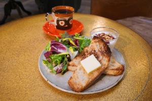 a plate of food with toast and salad and a cup of coffee at yaora in Kurashiki