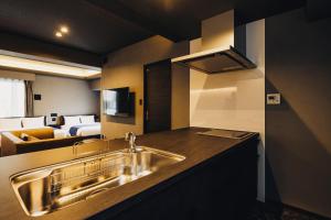a kitchen with a sink and a bed in a room at 慶 -Kei- HOTEL LIKE RESIDENCE in Fukuoka +84 photos