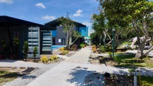 a walkway leading to a house with a building at dChamp Retreat in Changlun