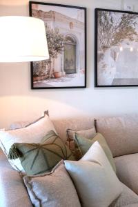 a living room with a couch with two pictures on the wall at Waterfront Stay at Sunshine Villa in Maroochydore
