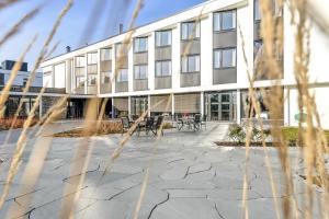 an office building with a patio in front of it at Hurdalsjøen Hotel & Spa in Hurdal