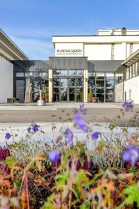 a building with purple flowers in front of it at Hurdalsjøen Hotel & Spa in Hurdal +104 photos