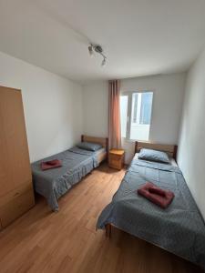 a room with three beds and a window at Cozy House with Free parking in Varna City