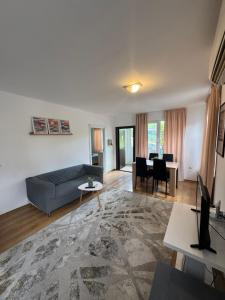 a living room with a couch and a table at Cozy House with Free parking in Varna City