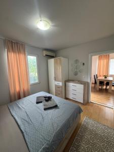 a bedroom with a bed and a dining room with a table at Cozy House with Free parking in Varna City