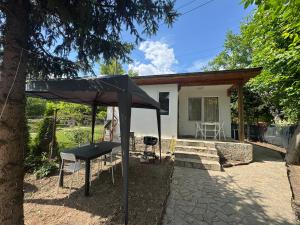 a black umbrella in front of a house at Cozy House with Free parking in Varna City