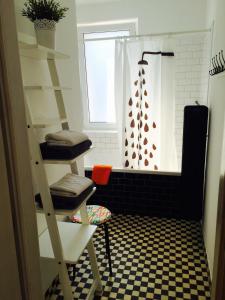 a bathroom with a ladder and a shower with a window at Apartament KoKi Retro in Gdynia