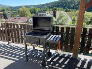 a grill with a laptop on top of a balcony at Wooden Bridge Residence in Radošov