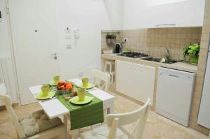 a kitchen with a table with a bowl of fruit on it at Antica Trani in Trani