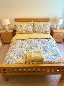 a bedroom with a large bed with two night stands at Luxurious two-bedroom apartment in the centre of Peterborough in Peterborough