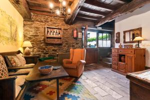 a living room with a couch and a table at Casa Rural Casa Mario in Cangas del Narcea