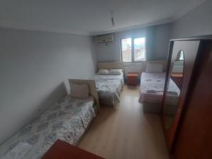 a small room with two beds and a couch at Paradıse lost otel in Degirmen