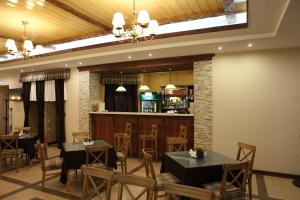 a restaurant with two tables and a bar at Hotel Gleden in Velikiy Ustyug