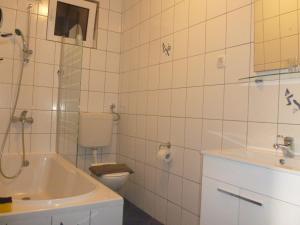 a bathroom with a tub and a toilet and a sink at Luna Apartments in Trogir +35 photos