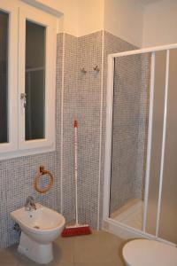 a bathroom with a shower and a toilet and a sink at Casetta Azzurra in Pomonte