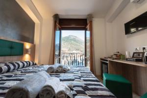 a bedroom with two beds and a view of a mountain at Il Risveglio del Cavaliere Casa Vacanza in Gioia dei Marsi