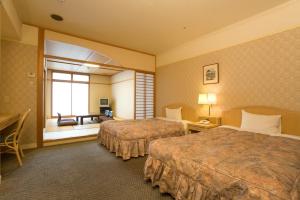 Säng eller sängar i ett rum på Hotel Sekia