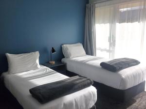 Voodi või voodid majutusasutuse Lake Dunstan Motel toas