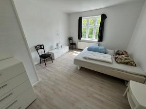 a bedroom with a bed and a desk and a window at Thistedvej 85C, Room 4 in Nørresundby