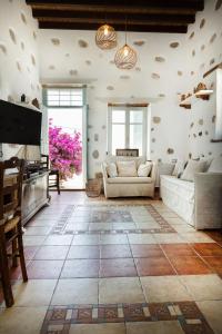 a living room with two couches and a television at Castro Nido in Astypalaia Town