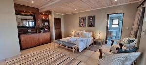 a bedroom with a bed and a living room at Nicola's Studio Apartment Knysna by First Private Stays in Knysna