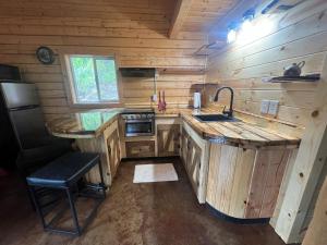 a kitchen with a sink and a stove in a cabin at Northern Nights Lodging in Palmer +24 photos