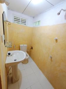 a bathroom with a white sink and a toilet at Villa Agrico and Surf Guest in Weligama +86 photos