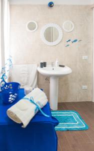 a bathroom with a sink and a white sink at Blue Suite in Castellammare del Golfo