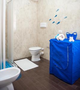 a bathroom with a toilet and a blue table at Blue Suite in Castellammare del Golfo