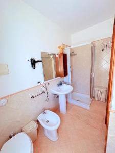 a bathroom with a sink and a toilet and a shower at Casa Joe in San Vito lo Capo +10 photos