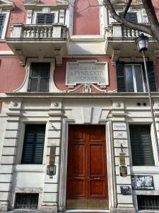 a building with a door and a sign on it at YouRoominRome in Rome