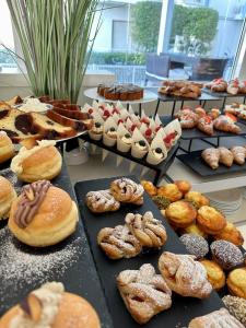 a display of different types of donuts and pastries at Hotel Nizza Frontemare Superior 3 Stelle in Lido di Jesolo
