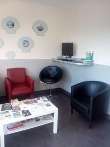 a room with a table and a chair and a desk with a computer at Albergue As Eiras in Lires