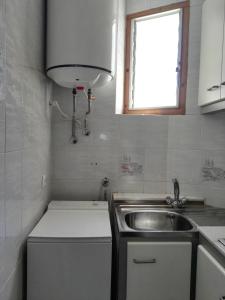 a small kitchen with a sink and a window at La Vila in Villajoyosa +41 photos