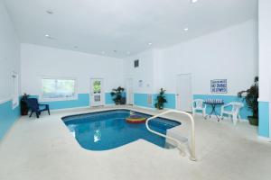 a swimming pool with a slide in a living room at Edge of Paradise in Pigeon Forge