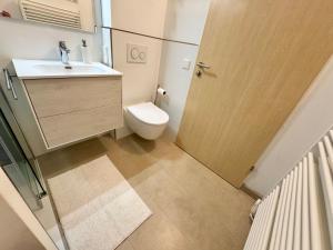 a small bathroom with a toilet and a sink at Scandi Apartment with Terrace and Parking in Karlsruhe