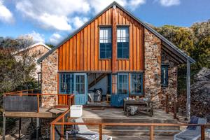 a house on a deck with a patio at Piermont Retreat in Swansea