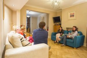 a group of people sitting in a living room at Chester Apartments in Chester